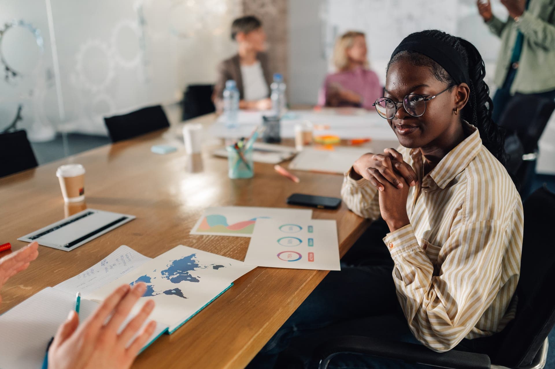 A graduate leading a corporate strategy meeting