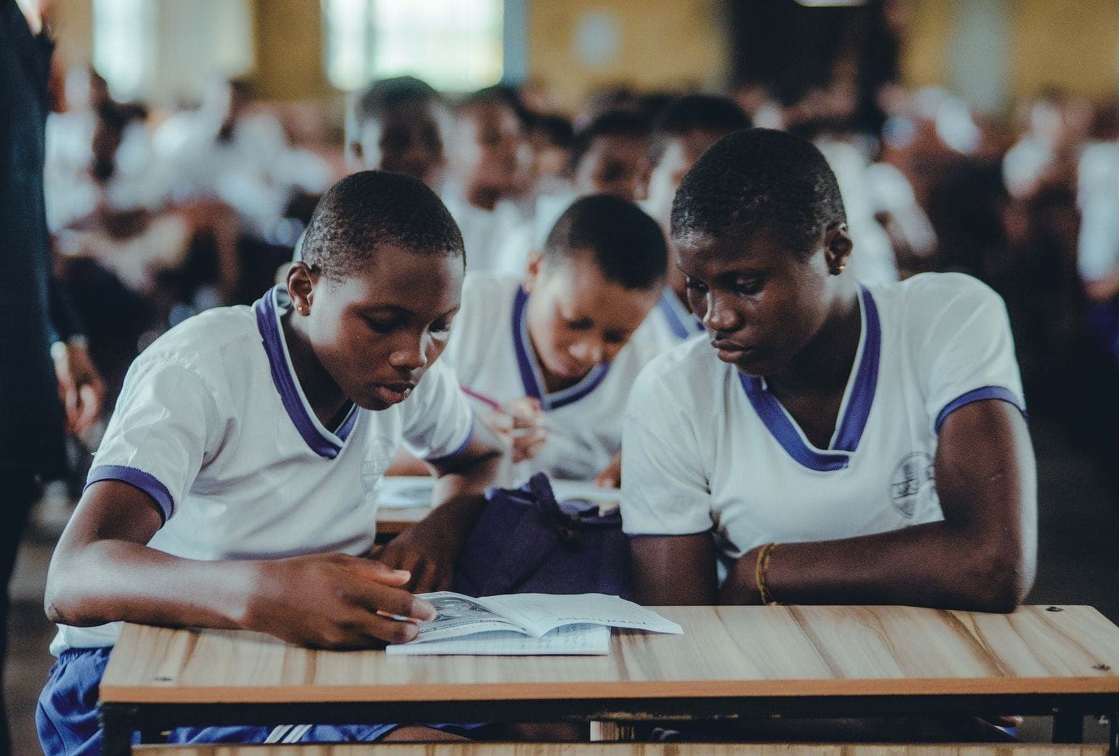 Junior secondary learners studying together at their desks